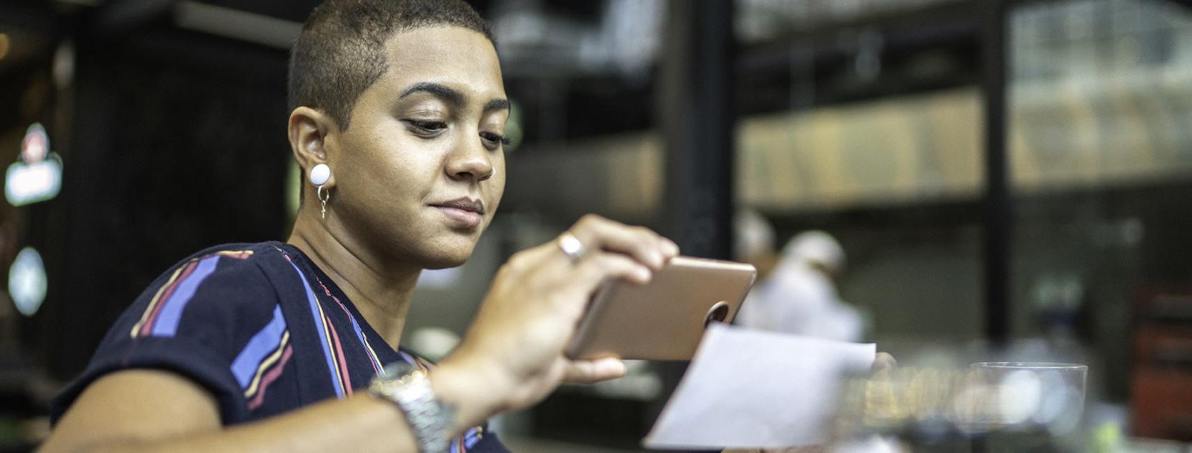 Woman depositing a check into her Patelco free checking account using the mobile app